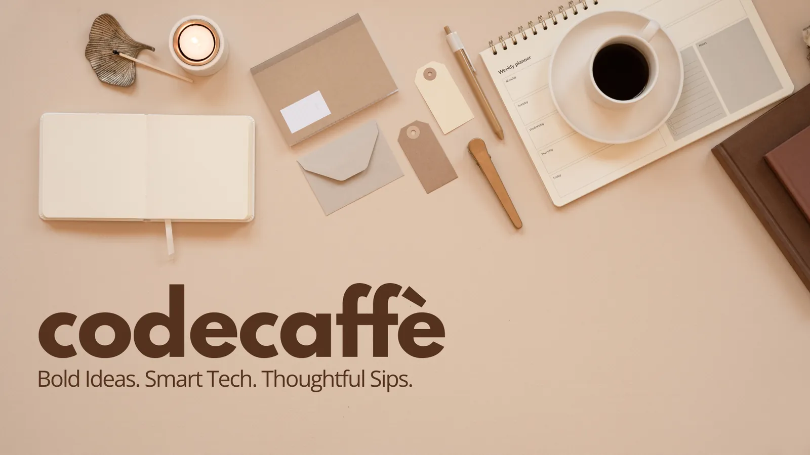 Flat lay of a coffee cup, notebook and stationery on a peach background, with the codecaffè logo and the line Bold Ideas. Smart Tech. Thoughtful Sips.